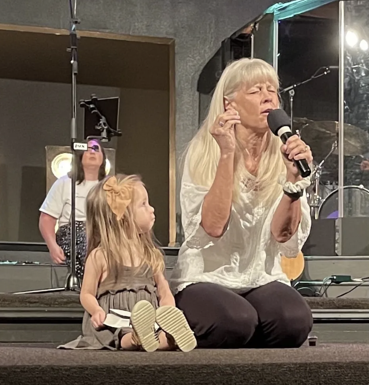 Marci sharing with a child during a gathering